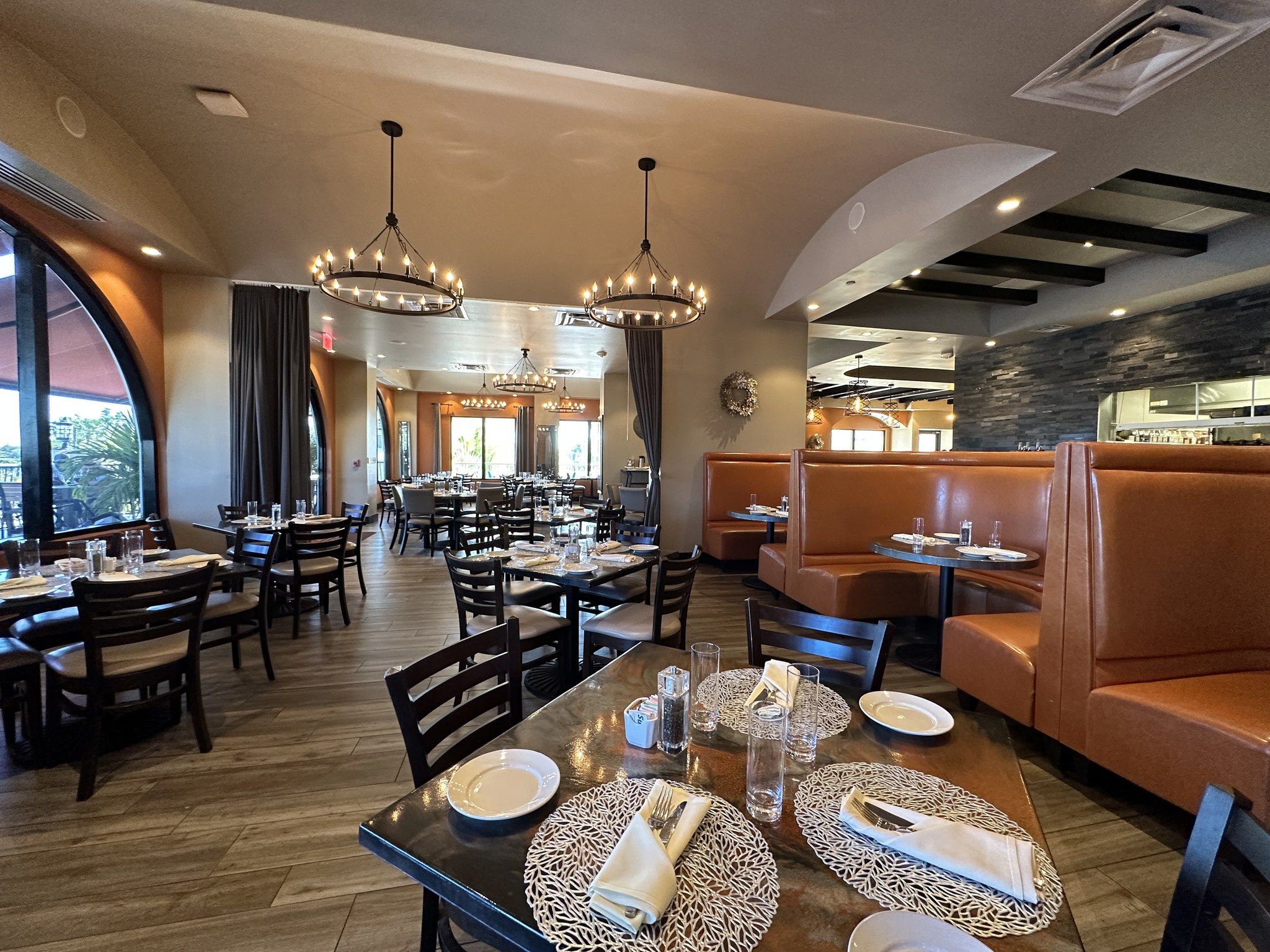 interior of Castile Restaurant in St Pete Beach with beautiful flooring, booths, and tables
