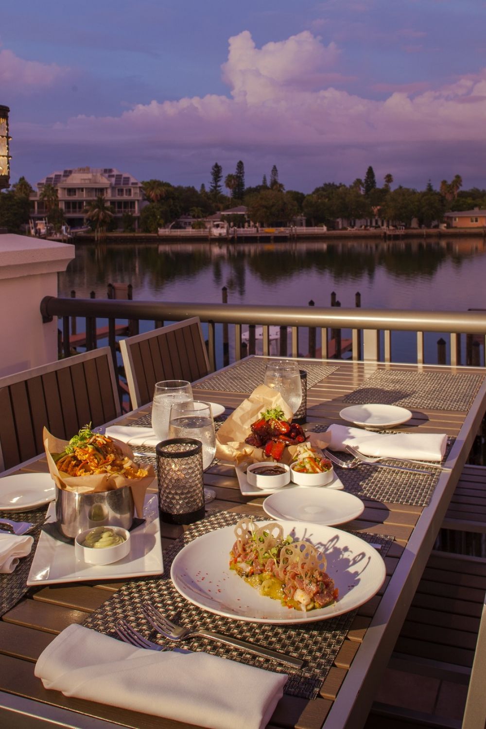 Rooftop bar table at dusk with plates